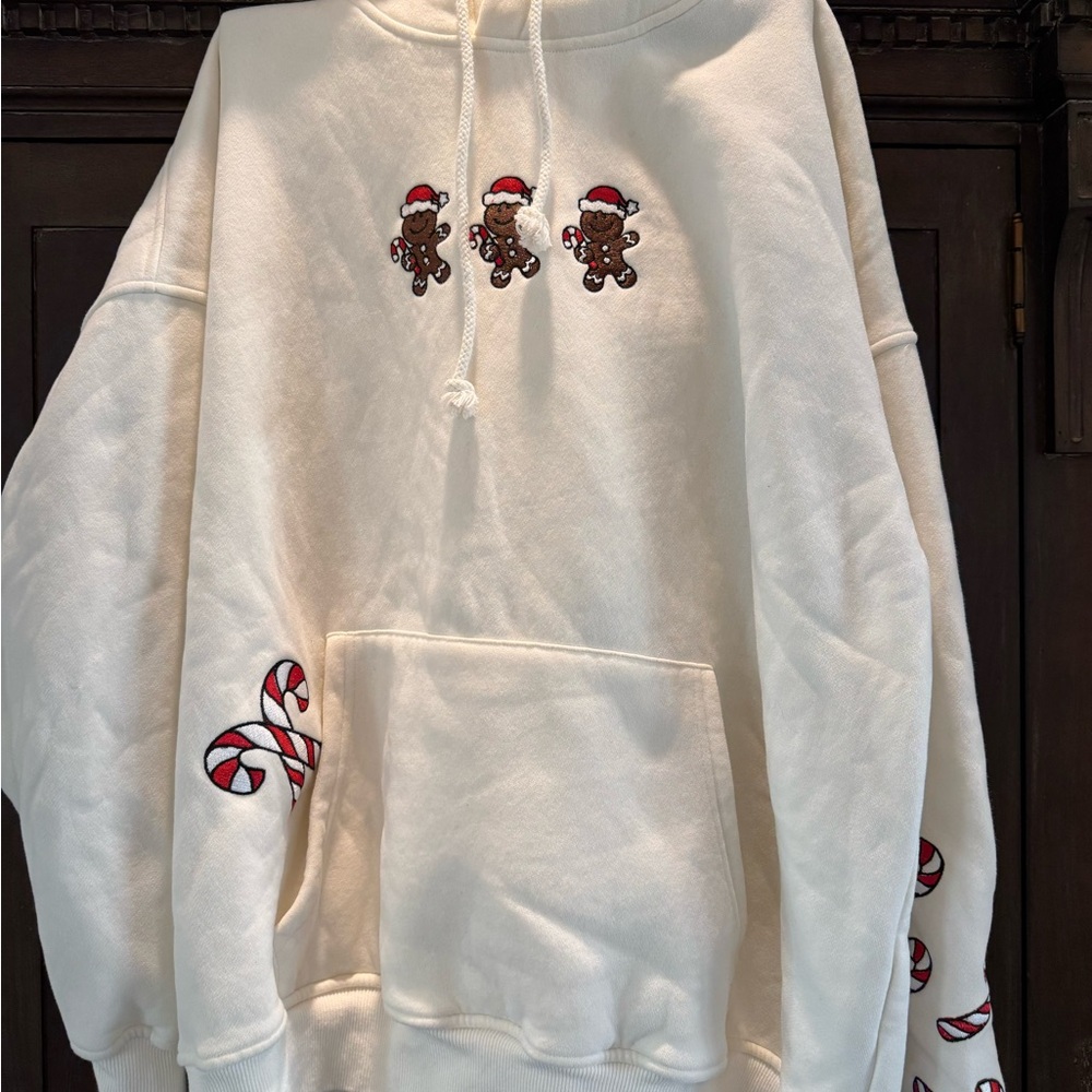 Festive Cream Hoodie with Gingerbread and Candy Cane Accents